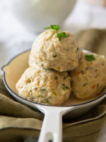 German bread dumplings stacked in a small serving skillet.