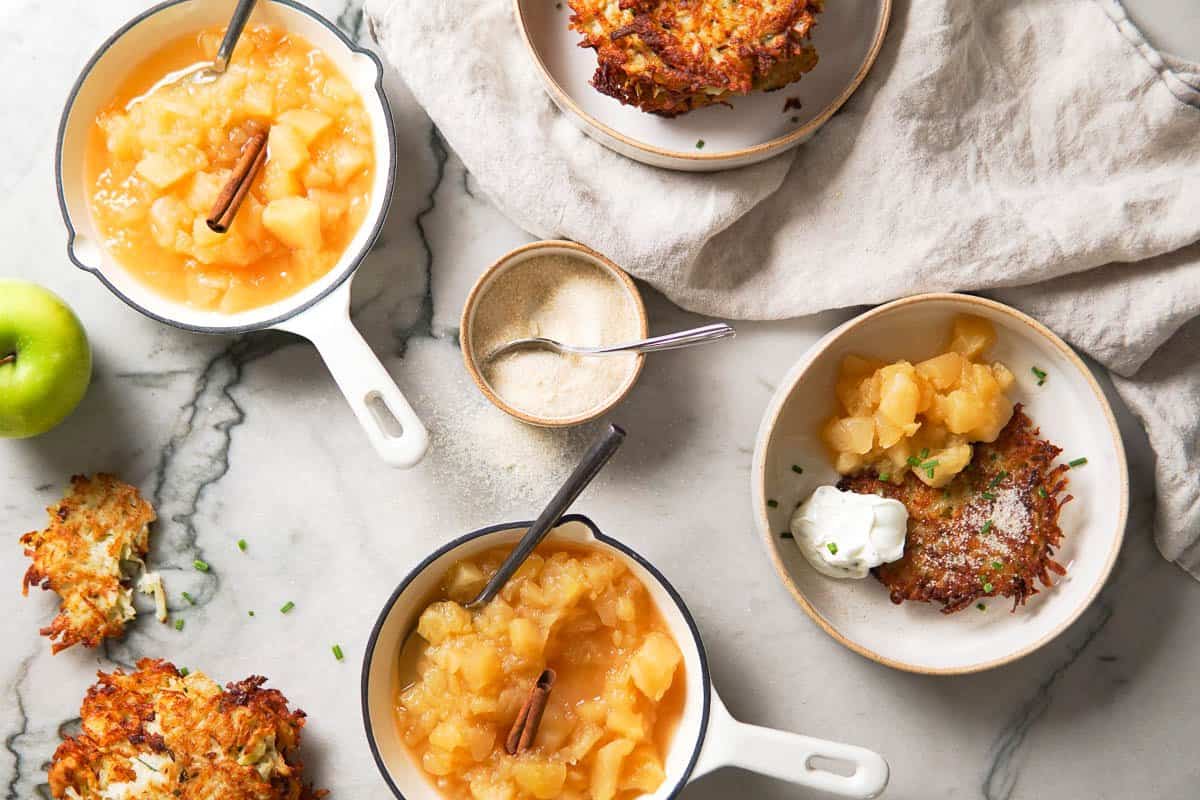 plates with potato pancakes and little skillets with applesauce