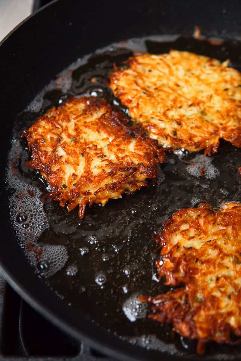 kartoffelpuffer frying in a pan