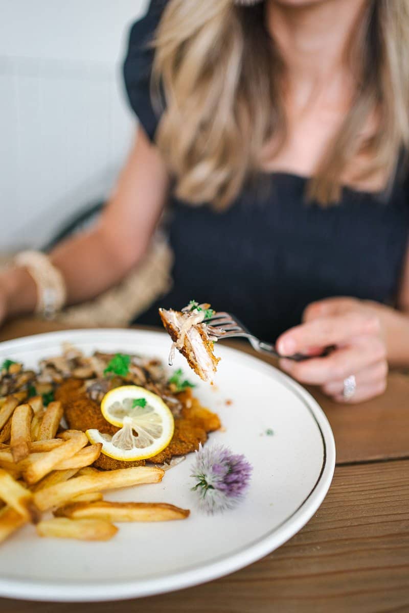 eating schnitzel with mushroom sauce