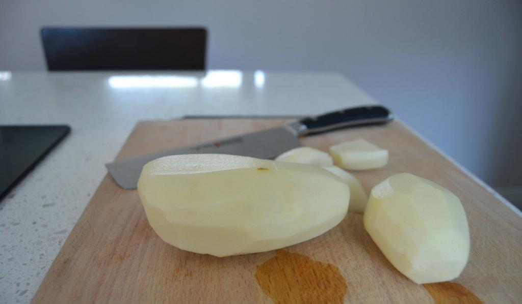 peeling and cutting up potatoes, so they cook faster and more evenly