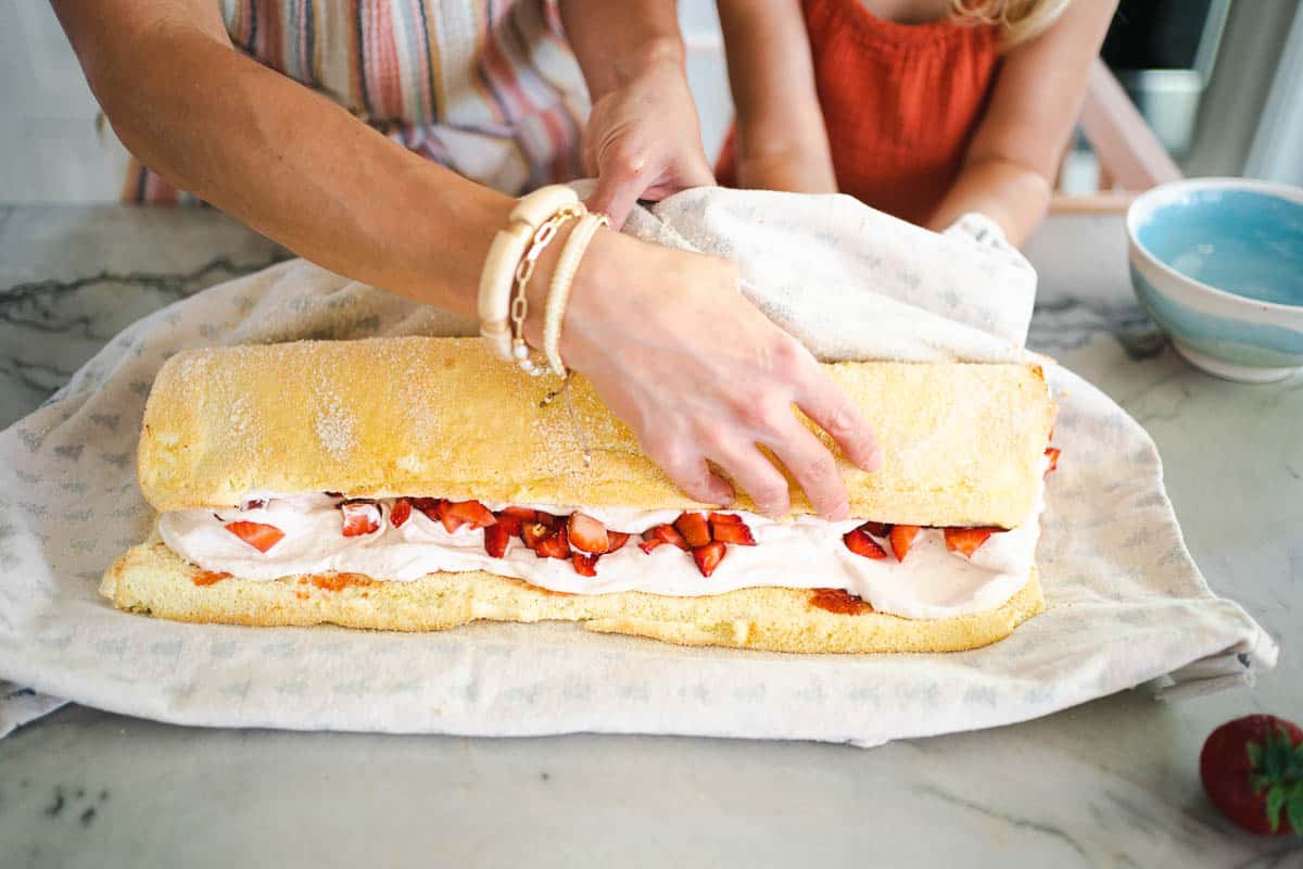 rolling up the strawberry cream cake