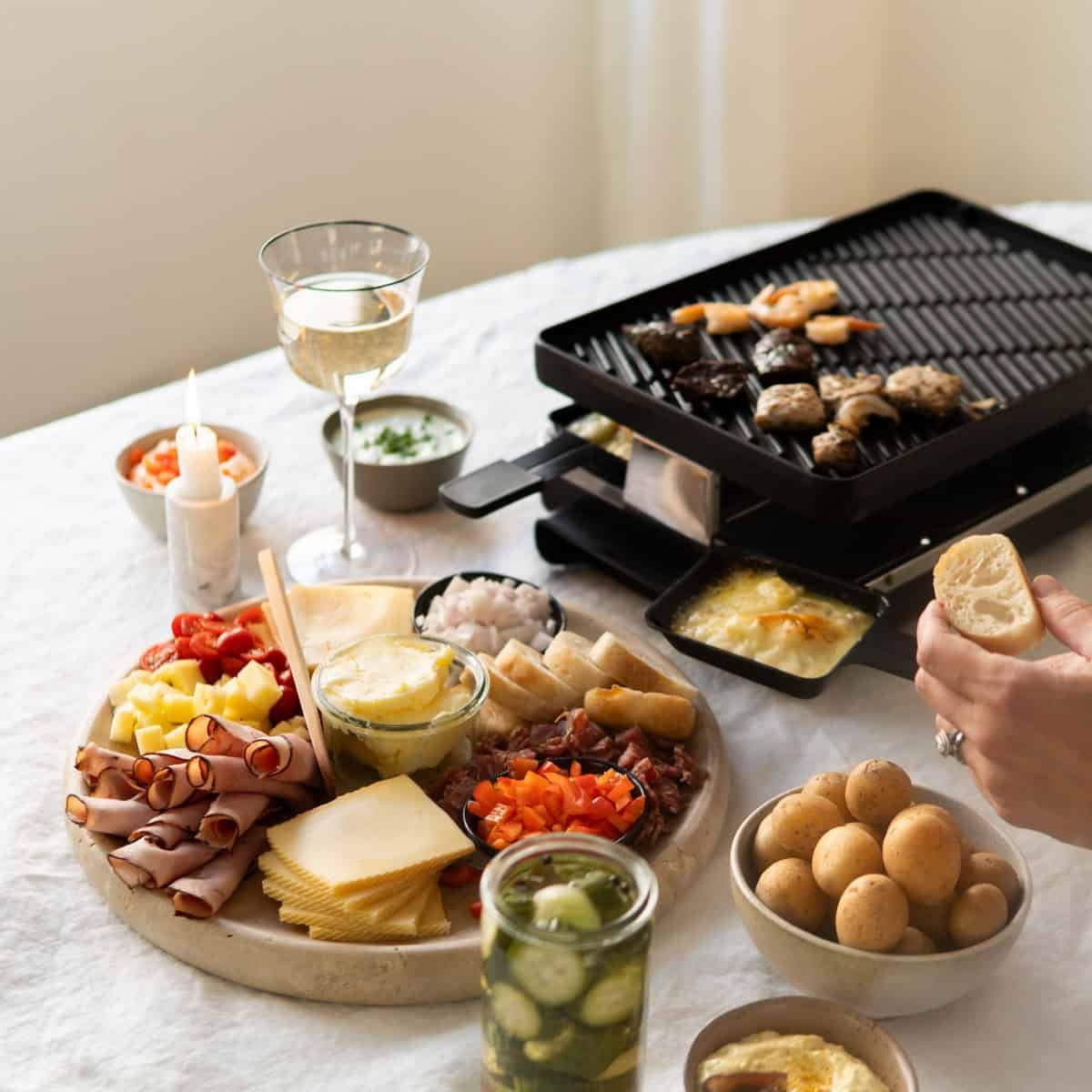 raclette cheese melting on a raclette grill