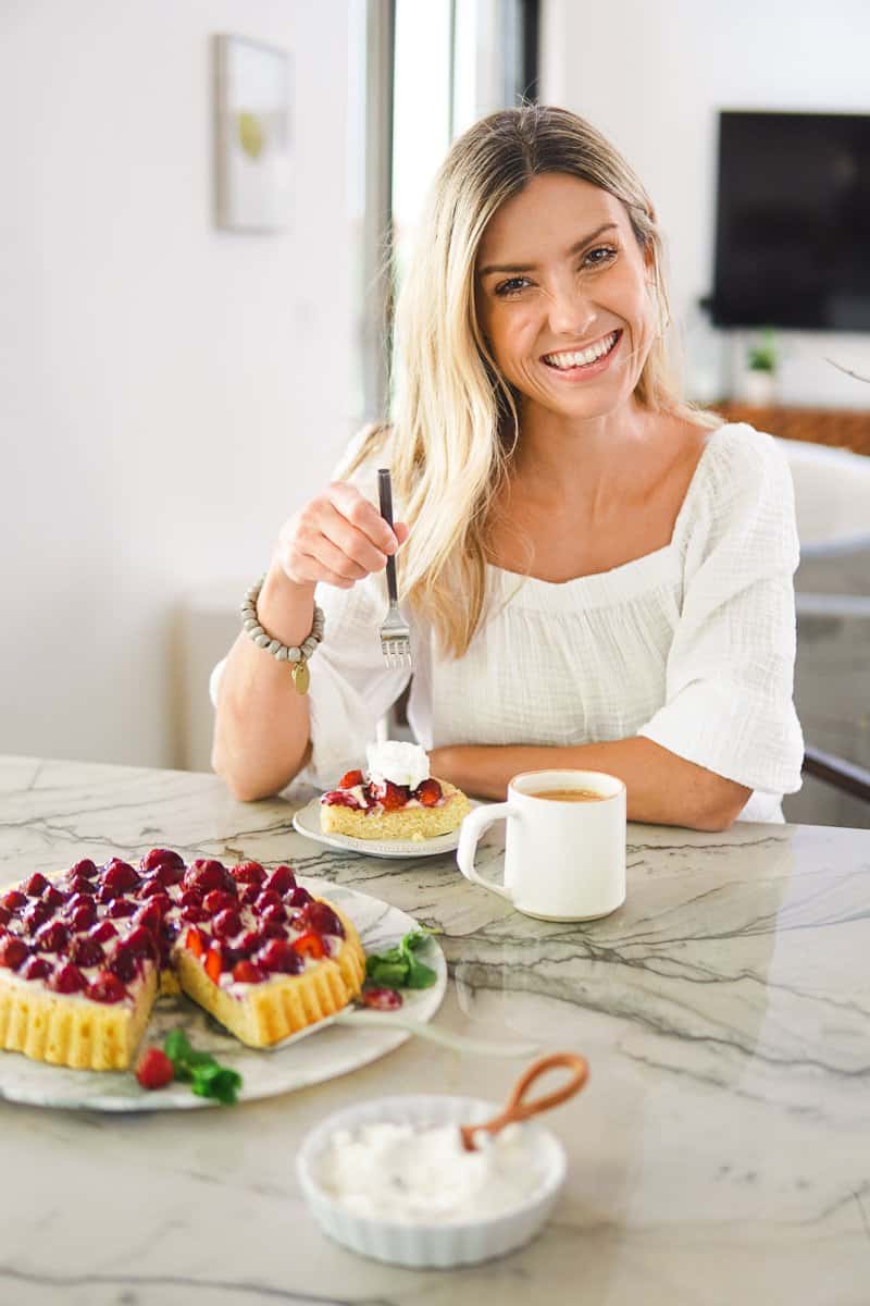 a girl eating strawberry cake