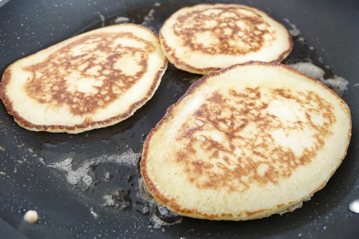 Baking the yeast pancakes in butter in a skillet