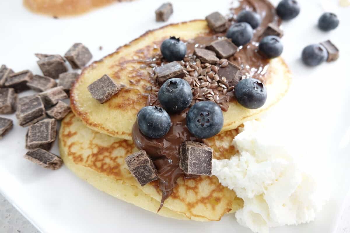 Yeast pancakes with Nutella, chocolate chunks, blueberries and flax seeds