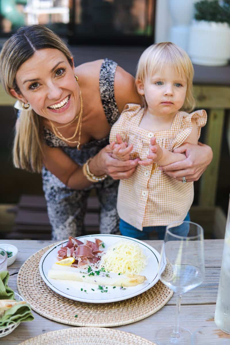 a plate with white asparagus, ham and potato snow and my daughter and me