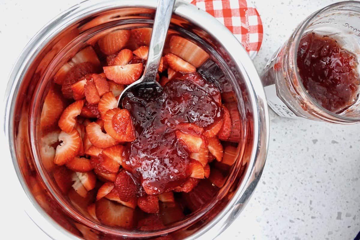 Marinating the sliced strawberries in jam