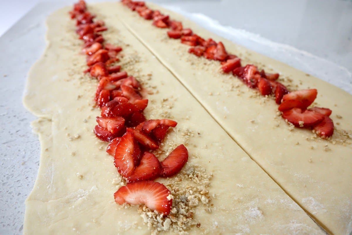 adding the strawberry filling to the dough