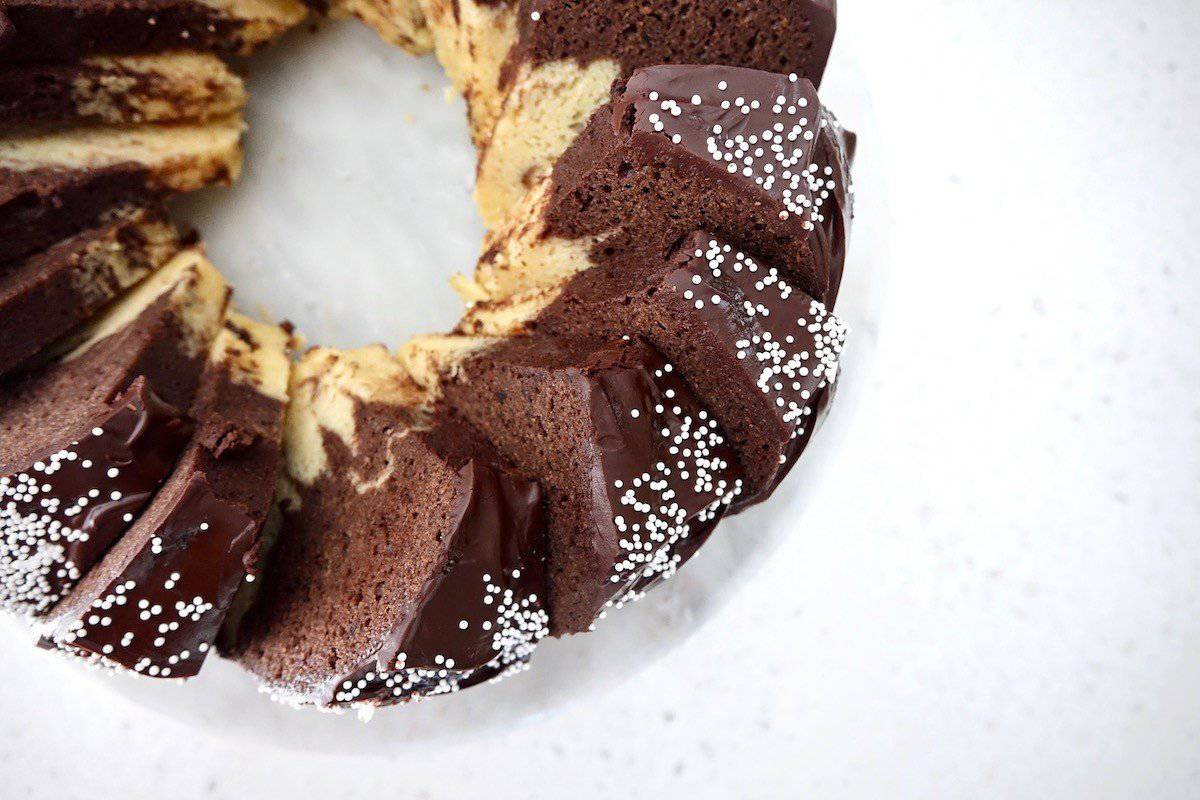 German marble cake baked with dark chocolate glaze and sprinkles