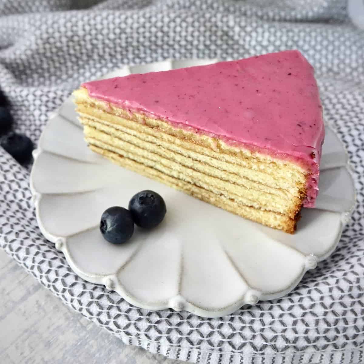 slice of blueberry glazed Baumkuchen on a ceramic plate