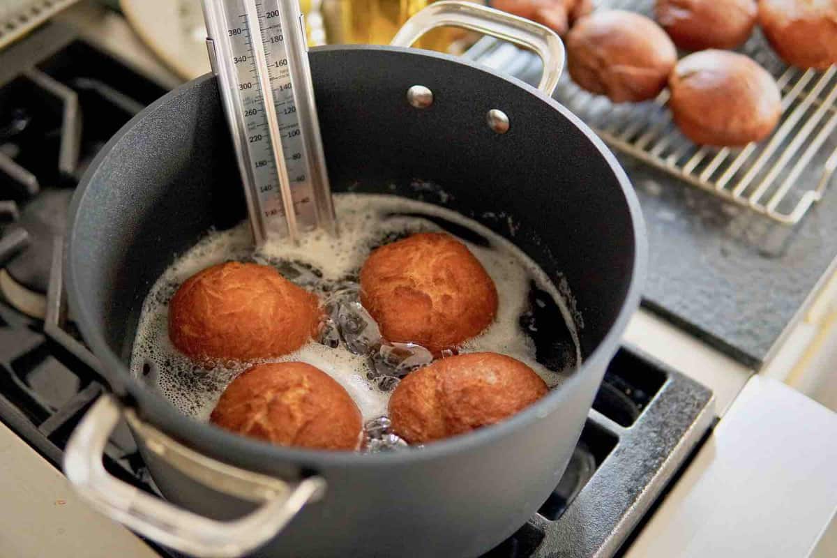 Berliner German donuts deep frying in a pot of hot oil