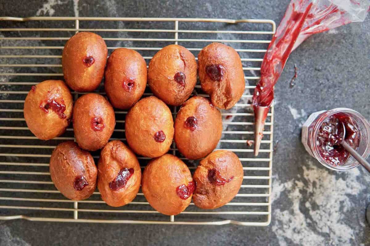 filling Berliner donuts with jam