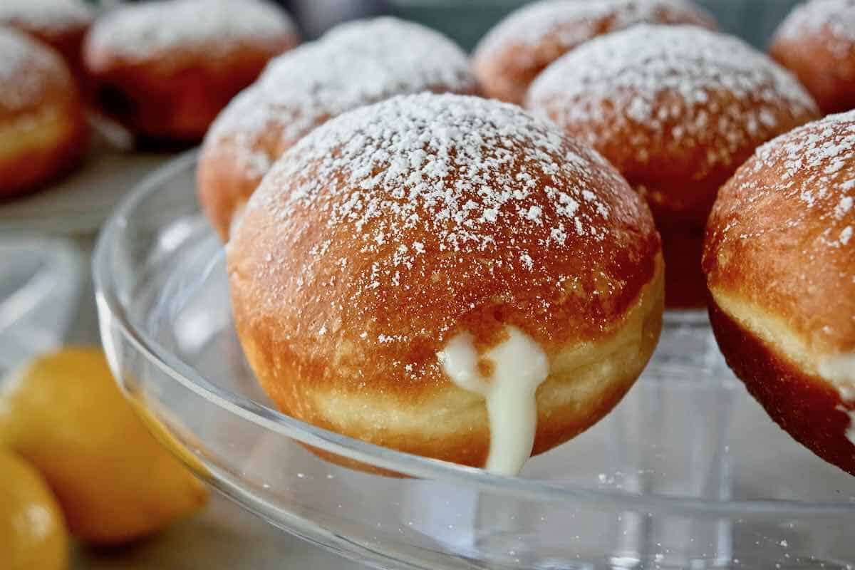 lemon donuts sitting on a glass platter