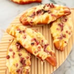 pretzels with bacon and cheese on a wooden board