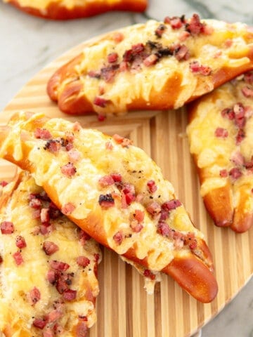 pretzels with bacon and cheese on a wooden board