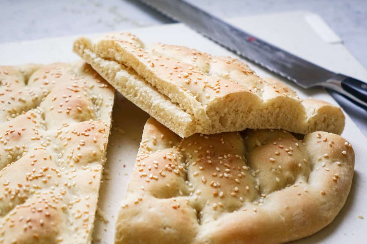 slicing open fresh baked, homemade Pide bread