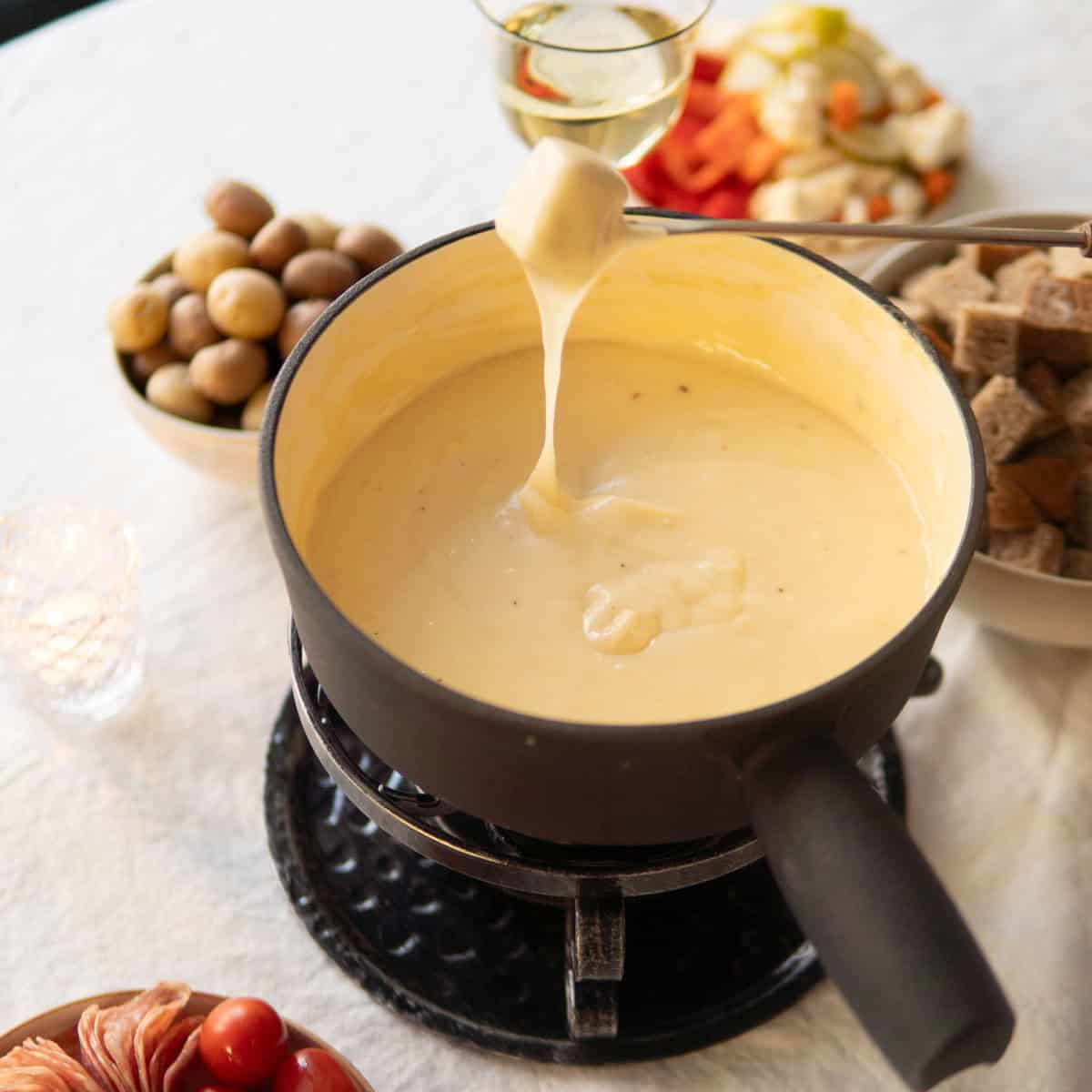 dipping bread in a pot of cheese fondue
