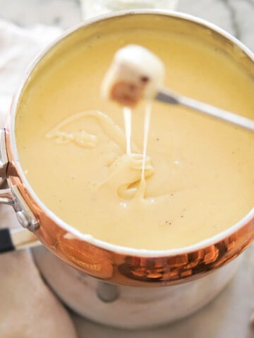 dipping bread in a pot of cheese fondue
