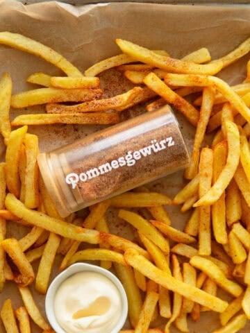 French fries on a platter with seasoning.