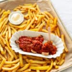 A currywurst with fries.