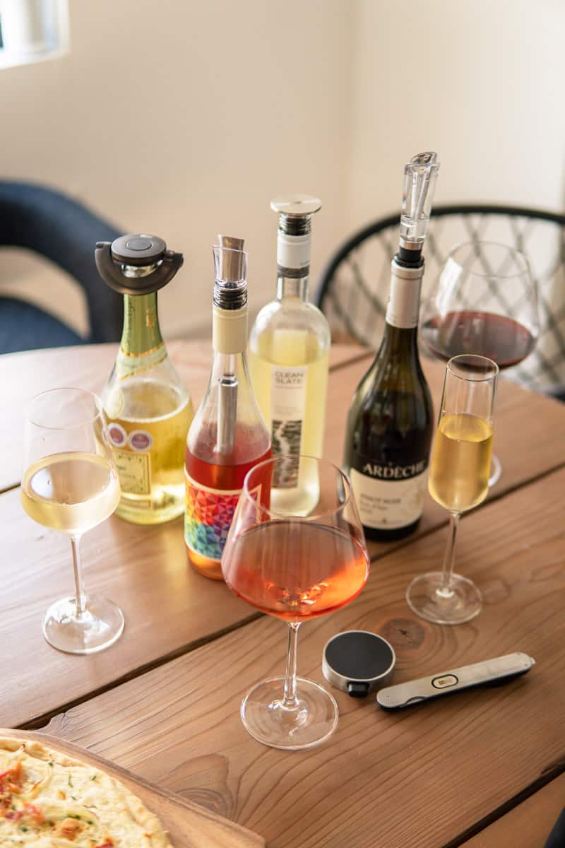 bottles of wine and glasses of wine on a table