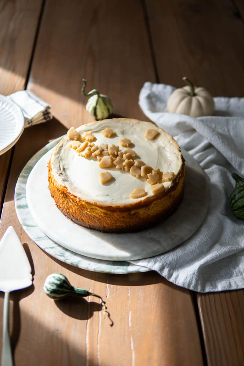 uncut pumpkin cheesecake with marzipan leaves on top