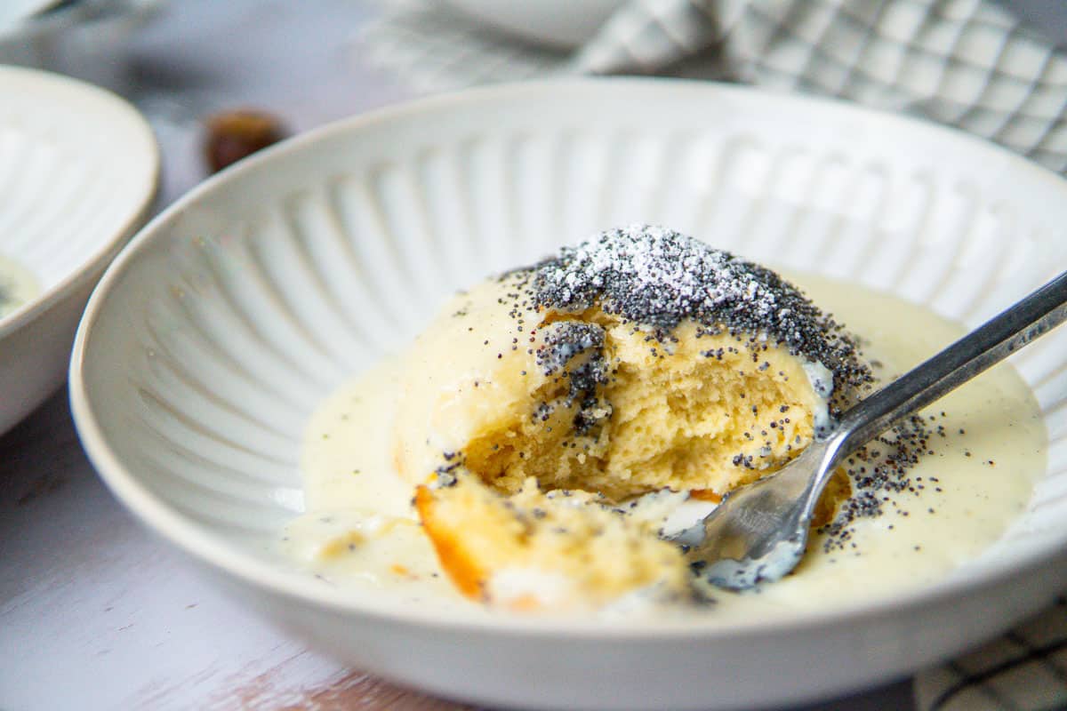 dampfnudel covered in vanilla sauce and poppy seed