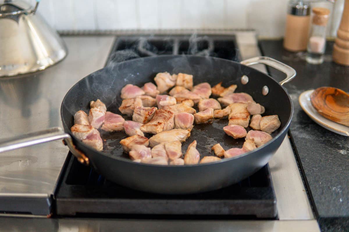 sautéing pork in the pan for goulash