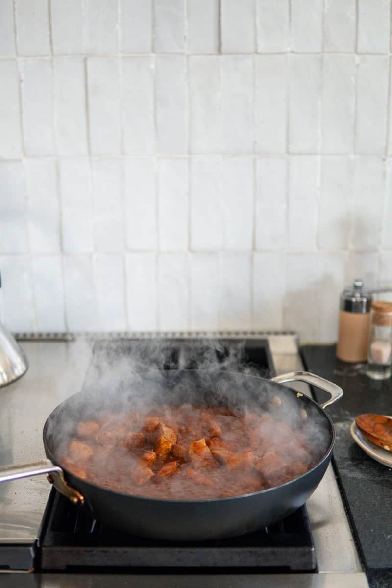 a pan of goulash cooking on the stove top