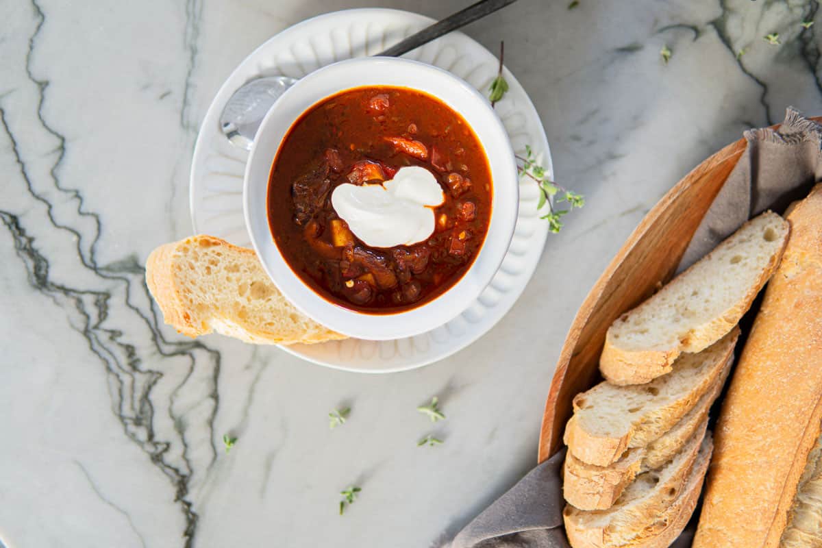 bowl of Hungarian goulash with sliced bread