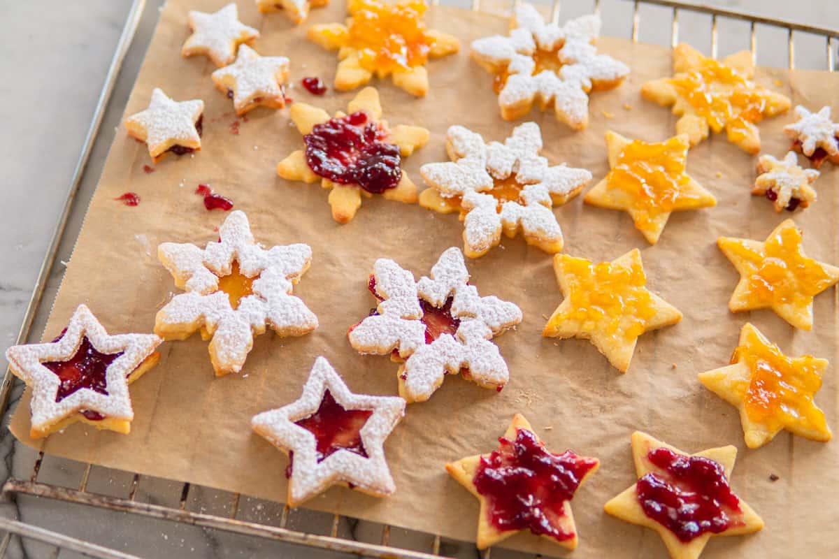 a baking sheet filled with Spitzbuben German christmas cookies