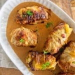 beef stuffed cabbage rolls on an oval platter garnished with parsley