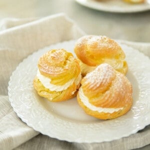 white plate topped with 3 filled cream puffs