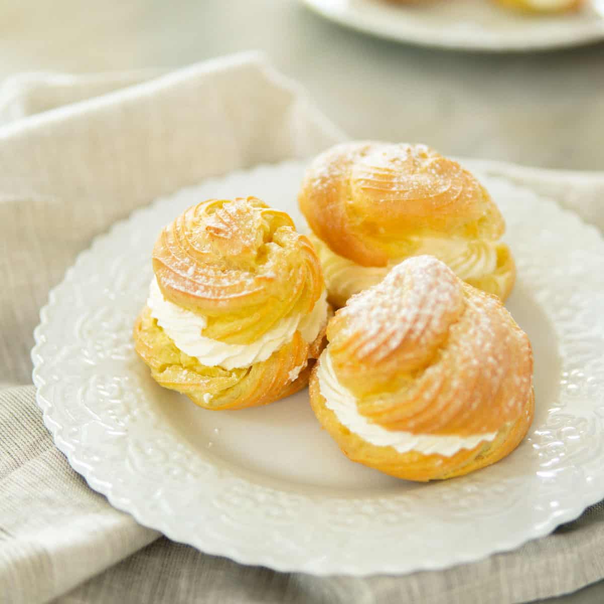 white plate topped with 3 filled cream puffs