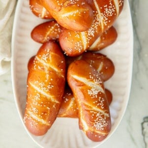 pretzel hot dog buns on a platter