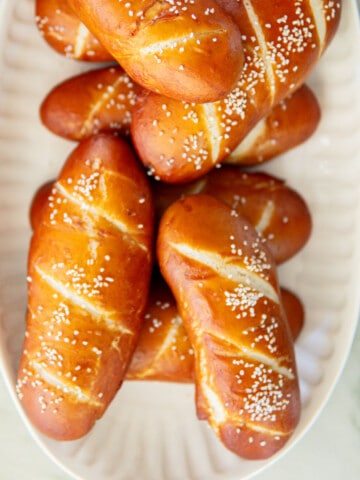pretzel hot dog buns on a platter