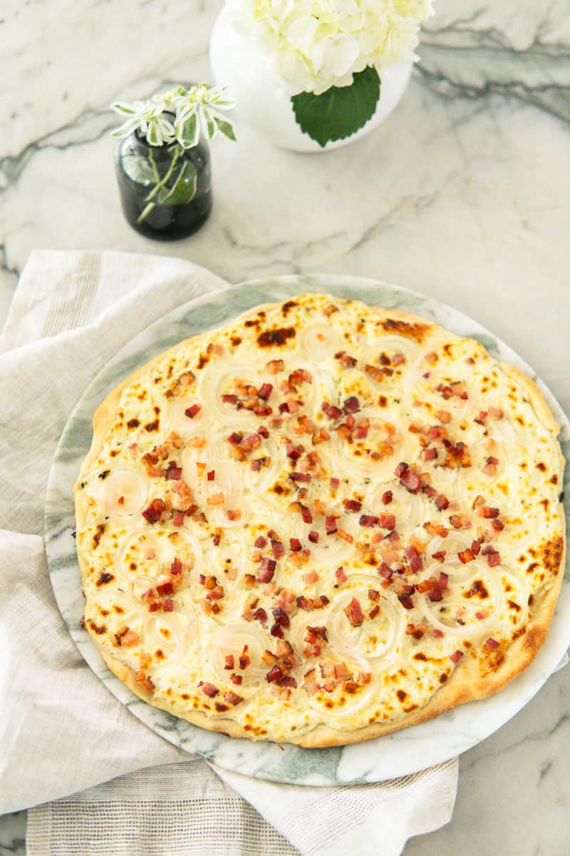 baked flammkuchen on a marble plate
