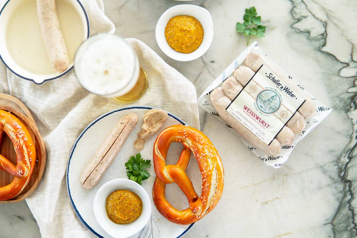 package of Weisswurst sausages, pretzel, sweet mustard and beer