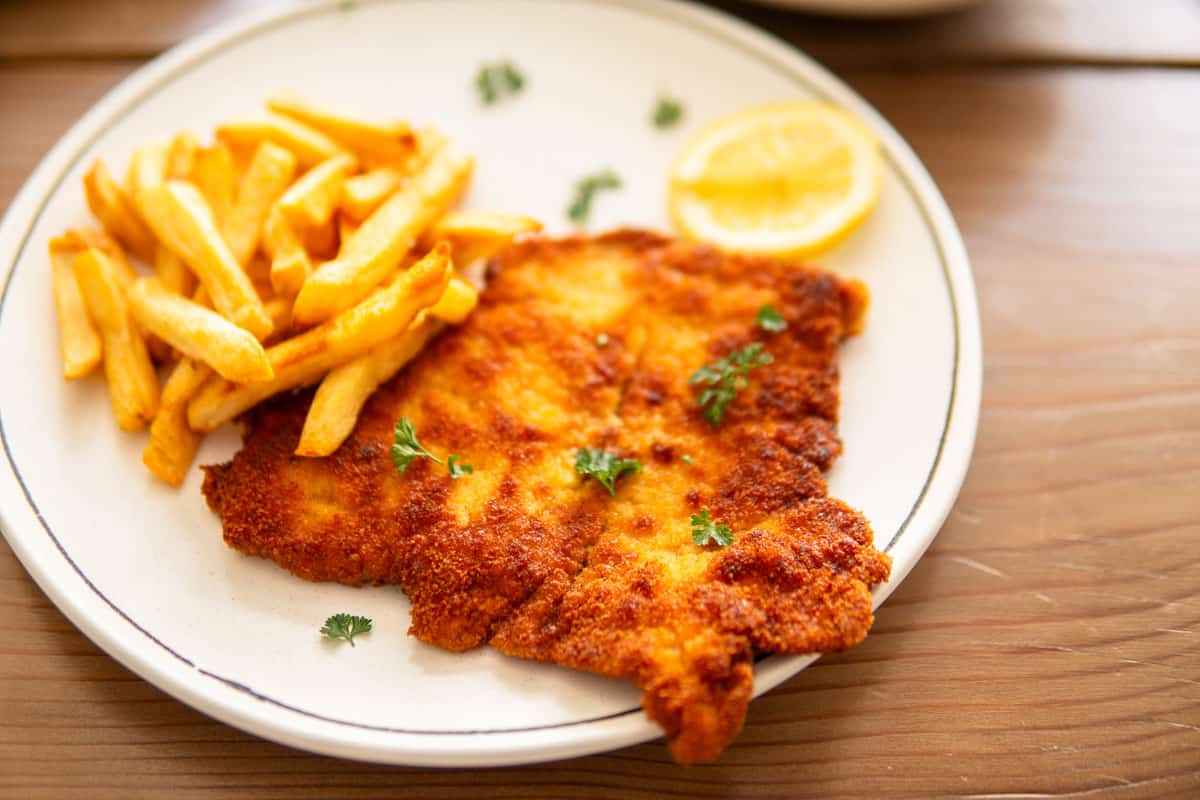 pork schnitzel on a plate with fries