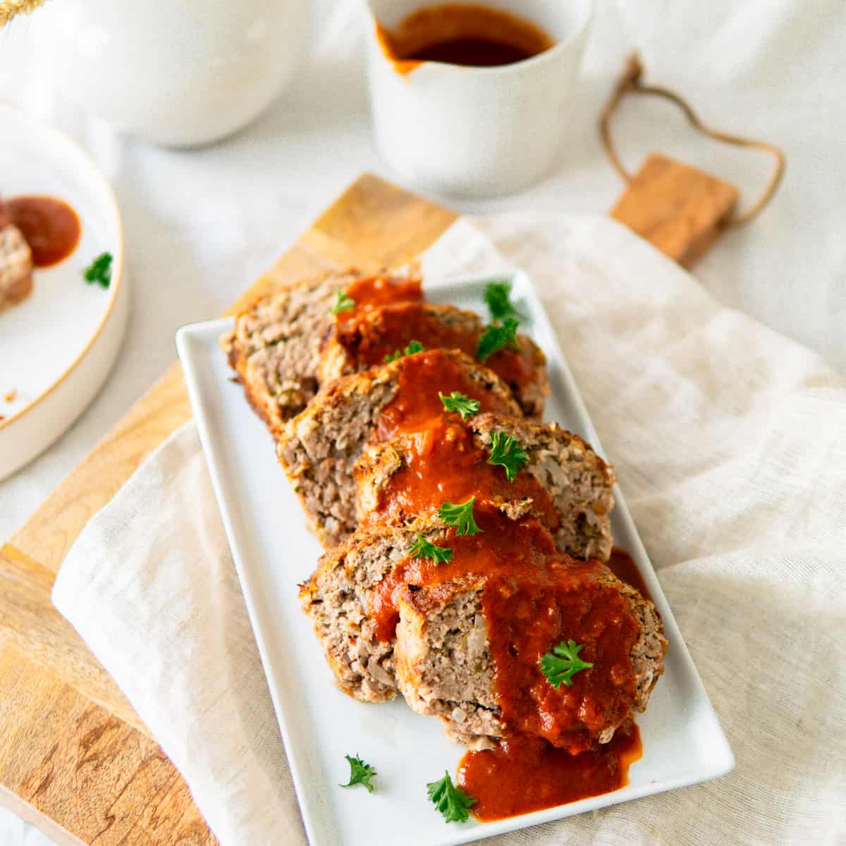 German meatloaf on a platter with sauce
