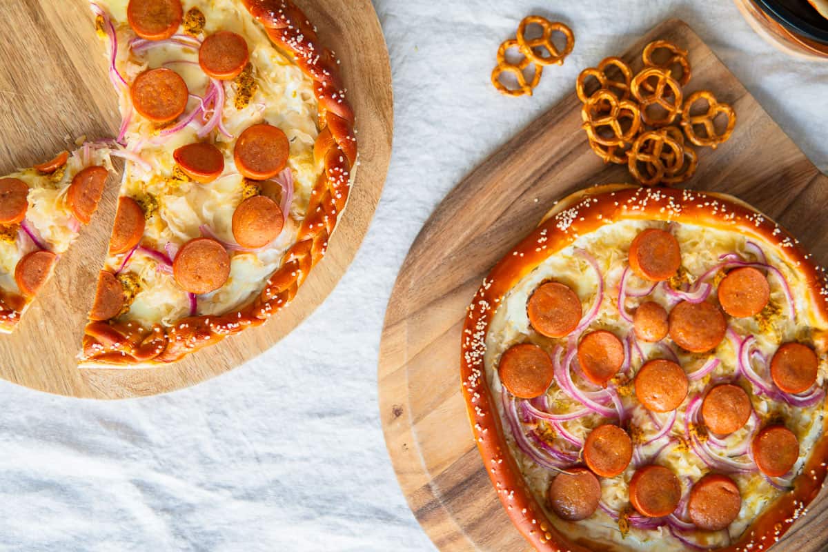 homemade pretzel pizzas on wooden boards