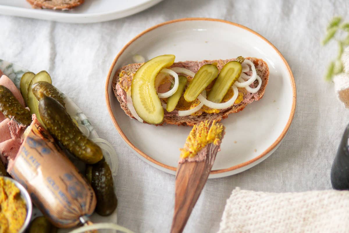 sliced bread topped with Leberwurst, pickles, mustard and onion.