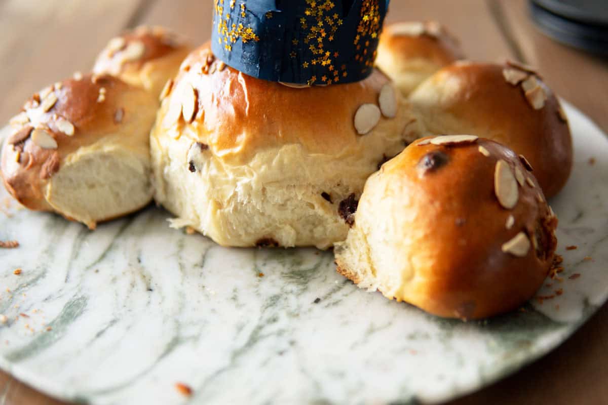 Side view and close-up of the Swiss Three King's Cake with 3 rolls missing.