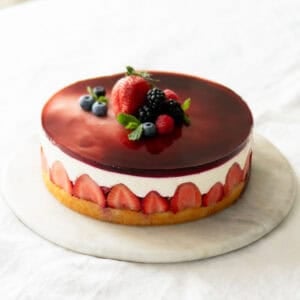 Assembled yogurt berry cake on a cake platter.