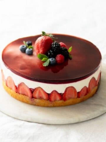 Assembled yogurt berry cake on a cake platter.
