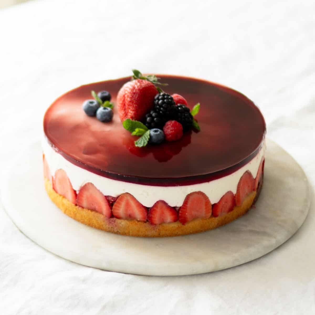 Assembled yogurt berry cake on a cake platter.