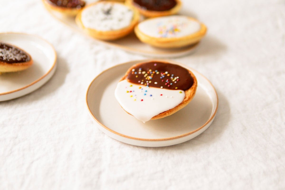 Close-up of Amerikaner pastry with lemon icing dripping down the side.