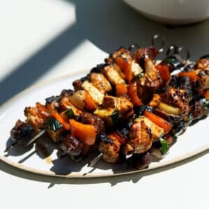 grilled chicken kabobs on an oval platter.