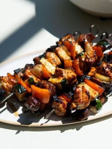 grilled chicken kabobs on an oval platter.